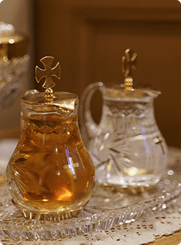 Cruets of wine and water with gold cross lids prepared for Catholic Mass