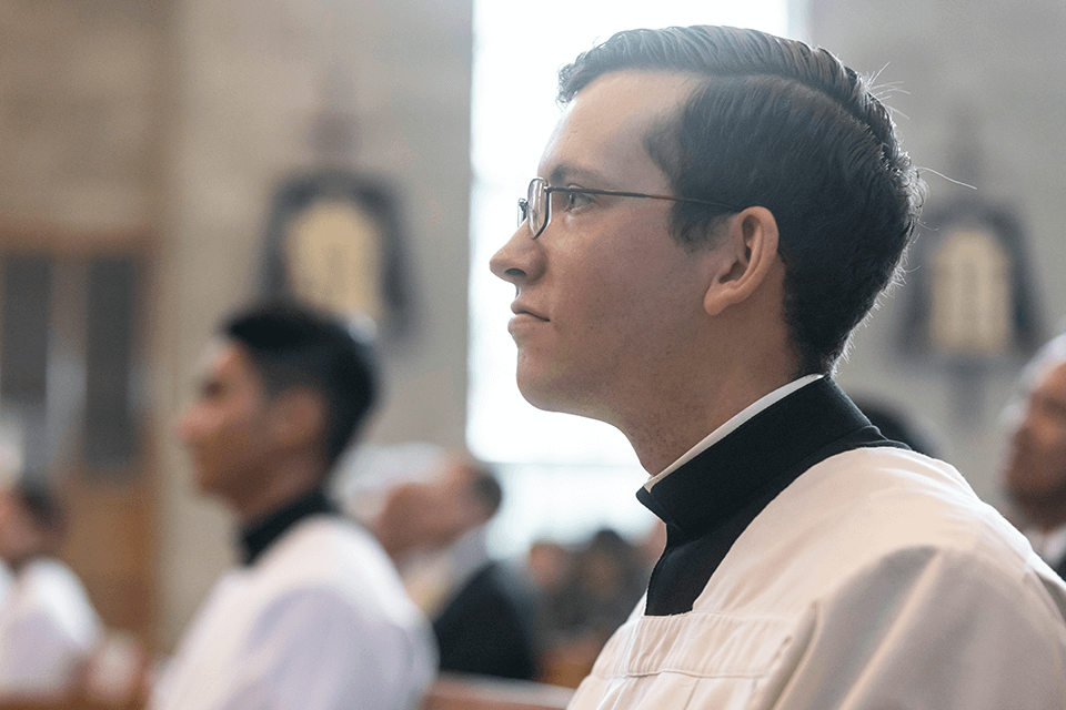 Catholic seminarian in prayer during Mass