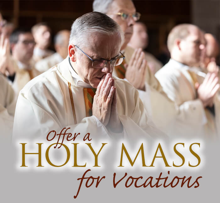 Priests praying together during Holy Mass for vocations